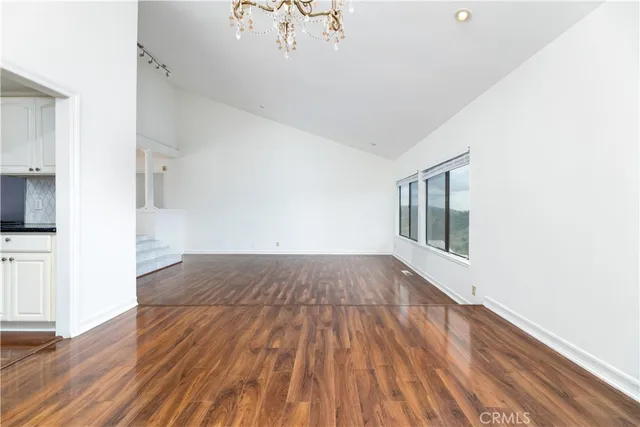 a view of a room with wooden floor and a window