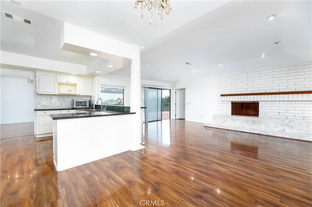 a view of kitchen with kitchen island microwave and stove