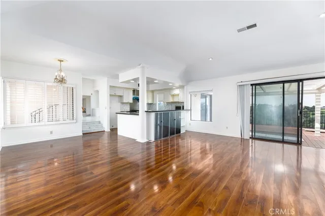 a view of a kitchen with wooden floor and a kitchen