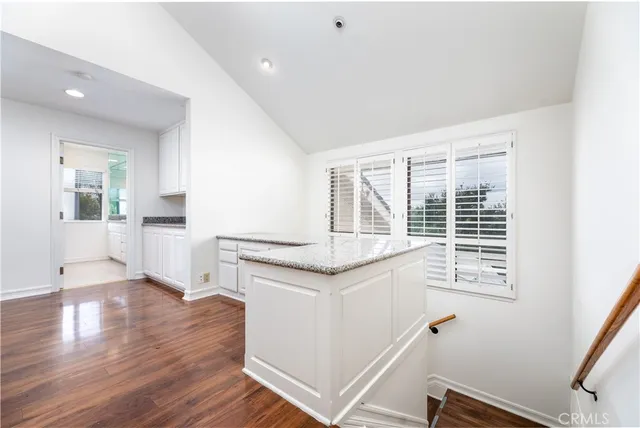 a open kitchen with granite countertop a stove and a sink