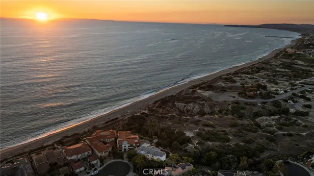 a living room with furniture a clock and a fireplace
