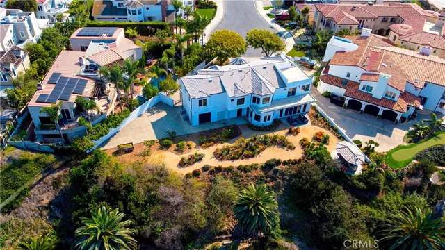 an aerial view of residential houses with city view