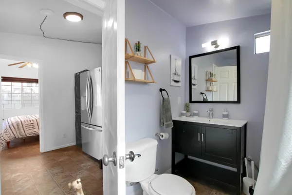 a bathroom with a sink toilet and mirror