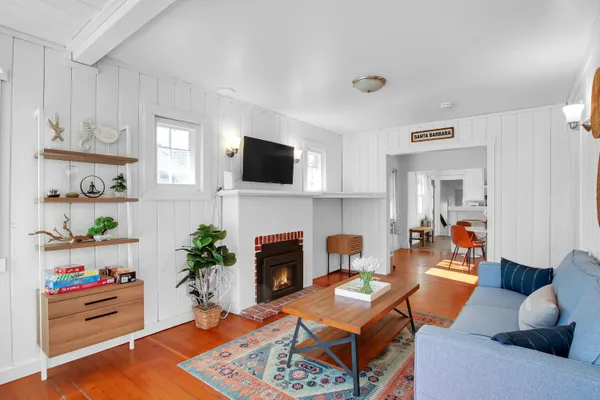 a living room with furniture a flat screen tv and a fireplace