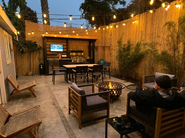 a view of a patio with dining table and chairs with a barbeque grill