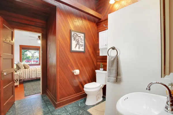 a bathroom with a toilet sink and mirror