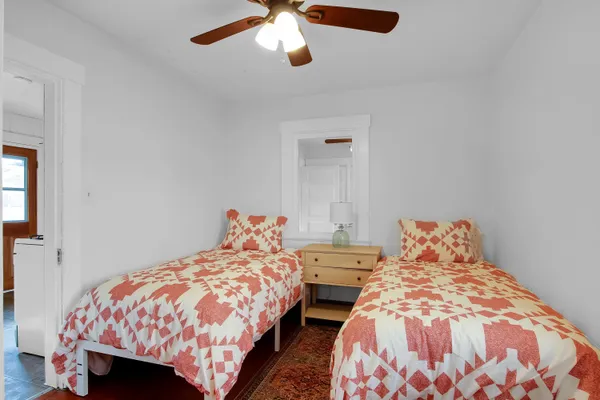 a bedroom with two beds and painted walls