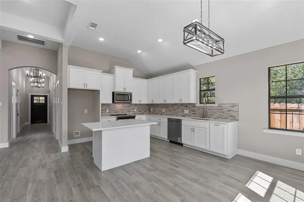 a kitchen with a refrigerator and a sink