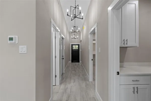 a view of a chandelier in hallway