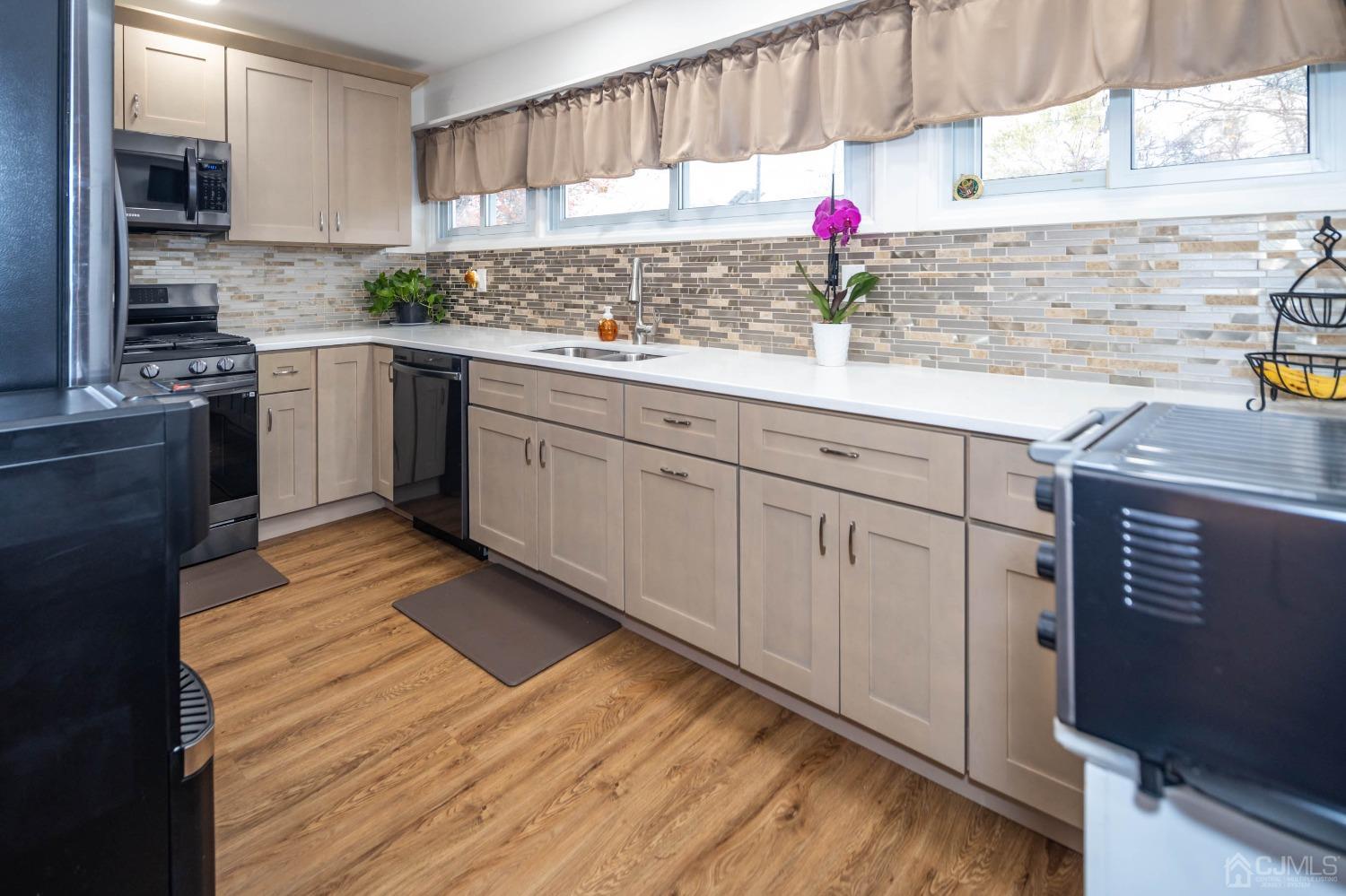 30 Cambridge Road Kendall Park, NJ 08824 - Photo 14 of 43 a kitchen with granite countertop a sink stainless steel appliances and cabinets