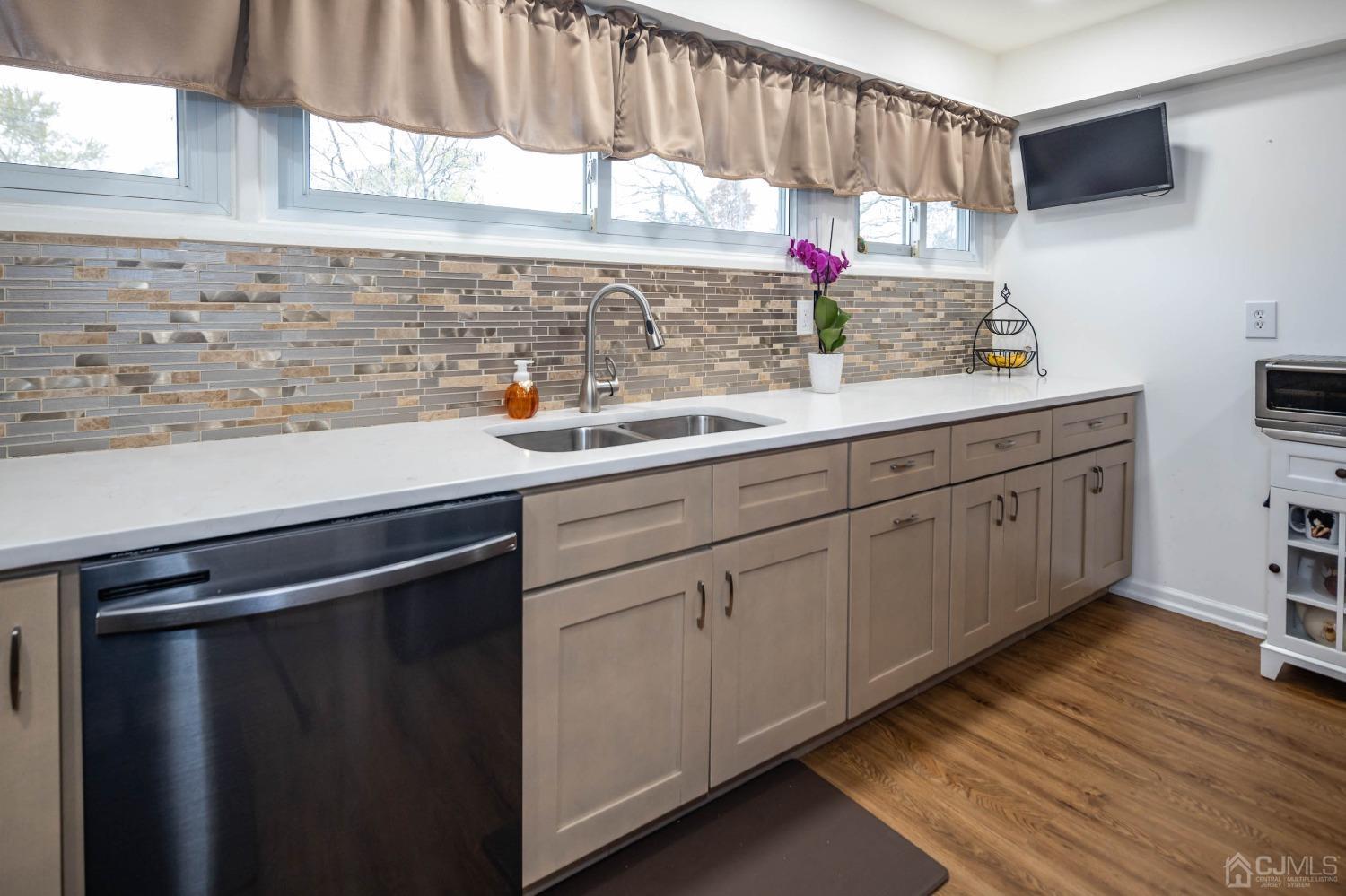 30 Cambridge Road Kendall Park, NJ 08824 - Photo 15 of 43 a kitchen with stainless steel appliances a sink dishwasher window and cabinets
