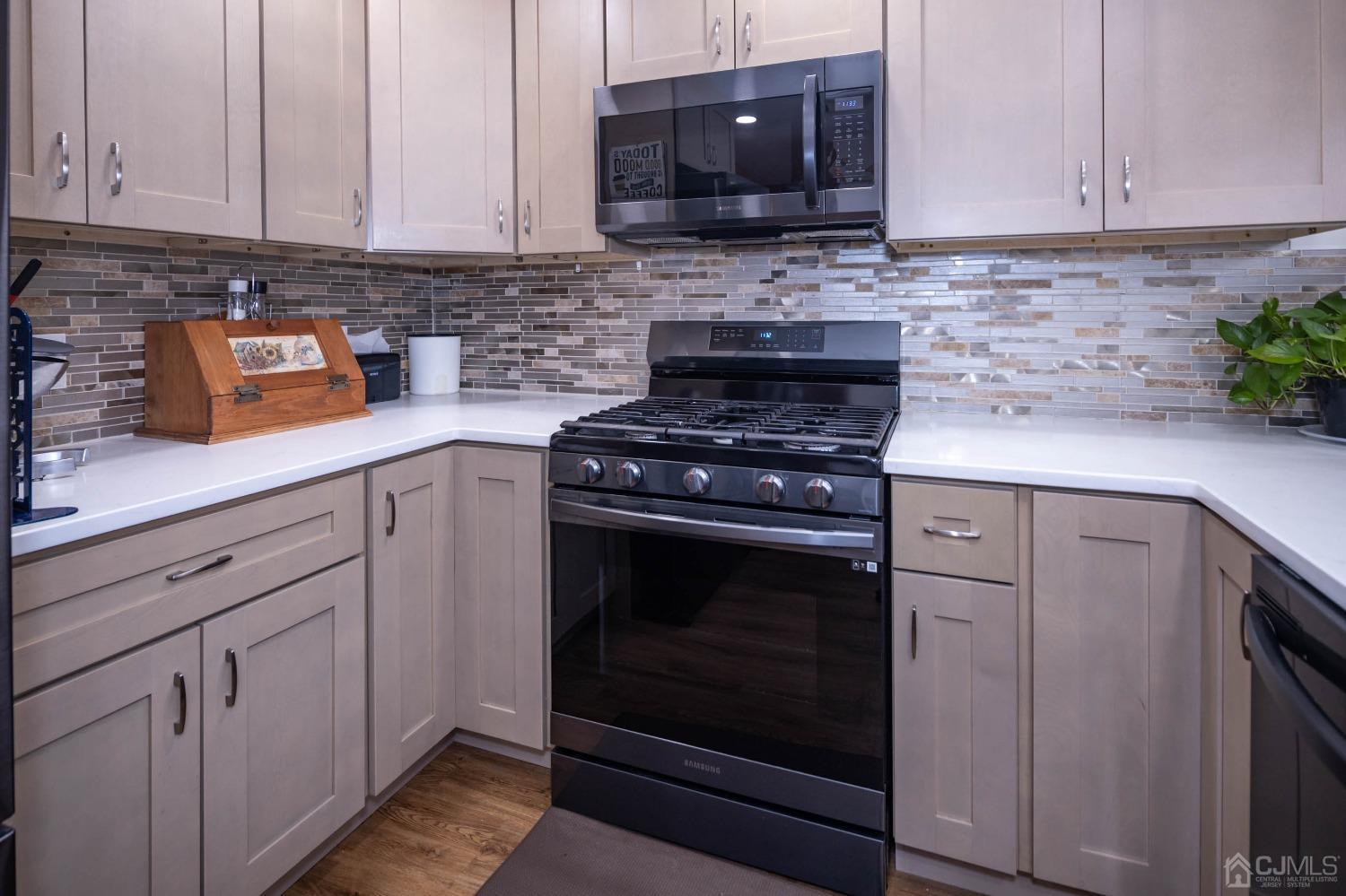 30 Cambridge Road Kendall Park, NJ 08824 - Photo 17 of 43 a kitchen with stainless steel appliances granite countertop cabinets and a stove top oven