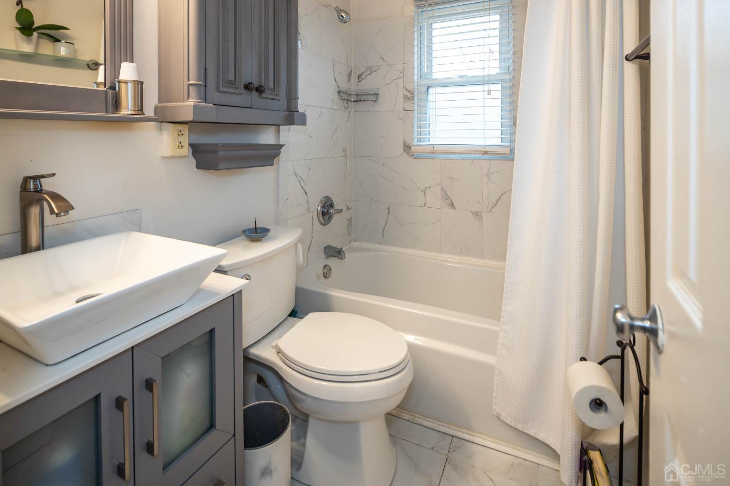 30 Cambridge Road Kendall Park, NJ 08824 - Photo 18 of 43 a bathroom with a sink toilet and shower