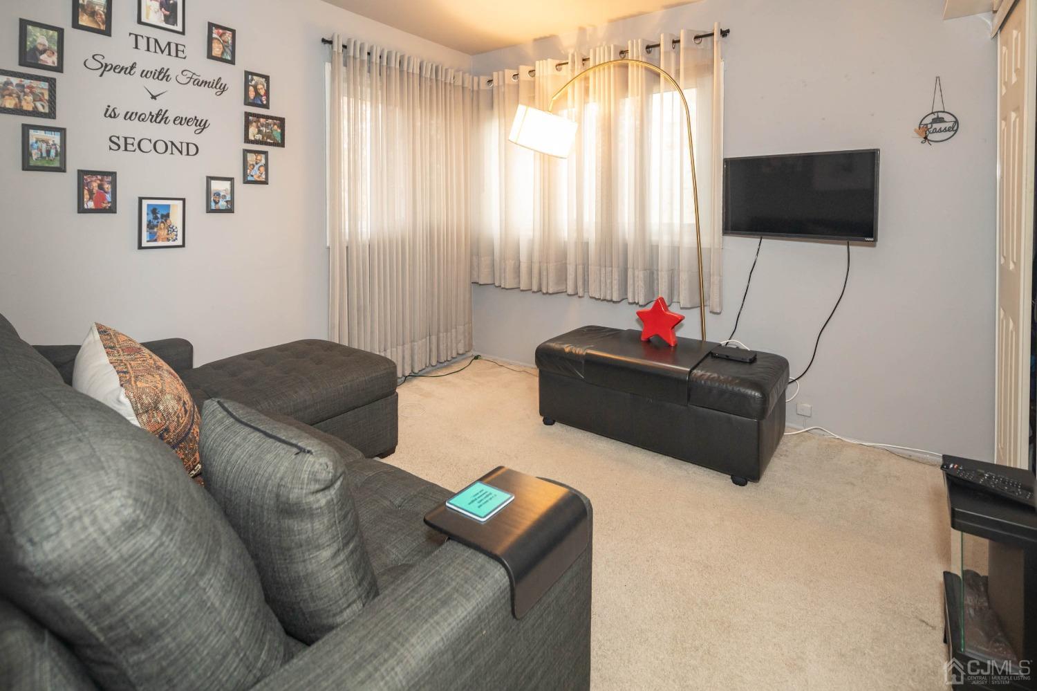 30 Cambridge Road Kendall Park, NJ 08824 - Photo 19 of 43 a living room with furniture and a flat screen tv