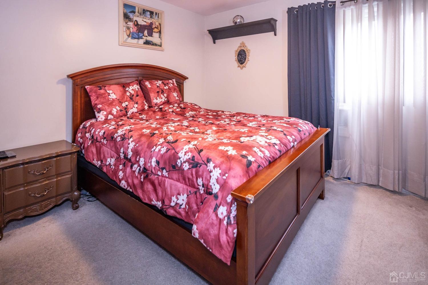 30 Cambridge Road Kendall Park, NJ 08824 - Photo 20 of 43 a bed sitting in a bedroom next to a window