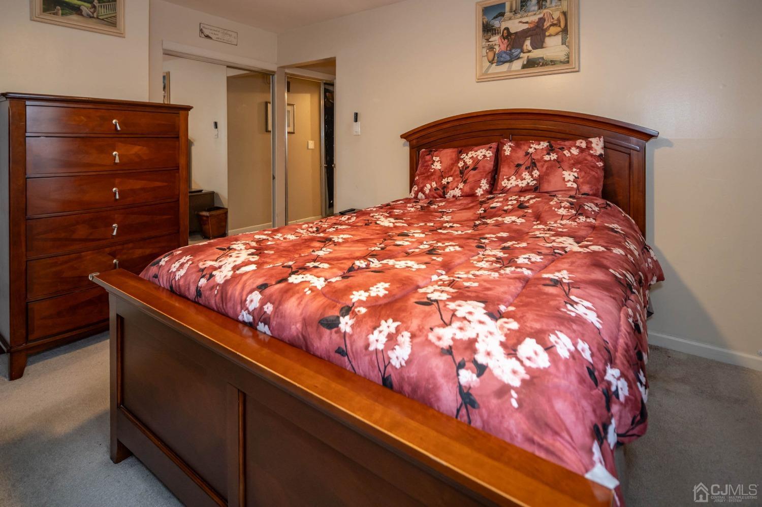 30 Cambridge Road Kendall Park, NJ 08824 - Photo 21 of 43 a large bed sitting in a bedroom next to a cabinet