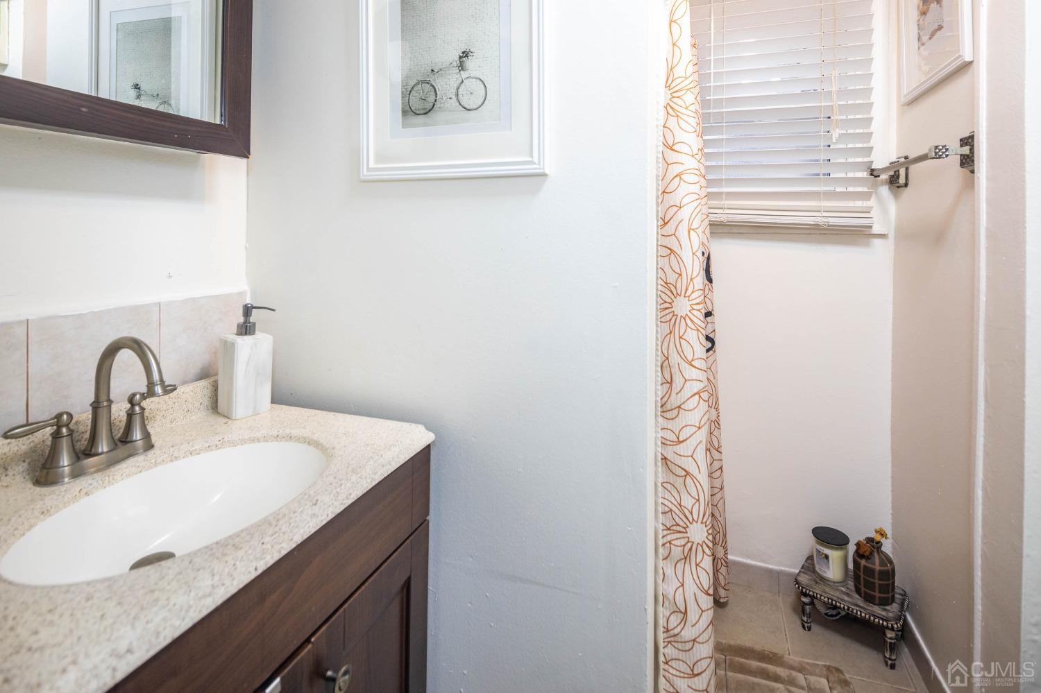 30 Cambridge Road Kendall Park, NJ 08824 - Photo 22 of 43 a bathroom with a sink and a mirror