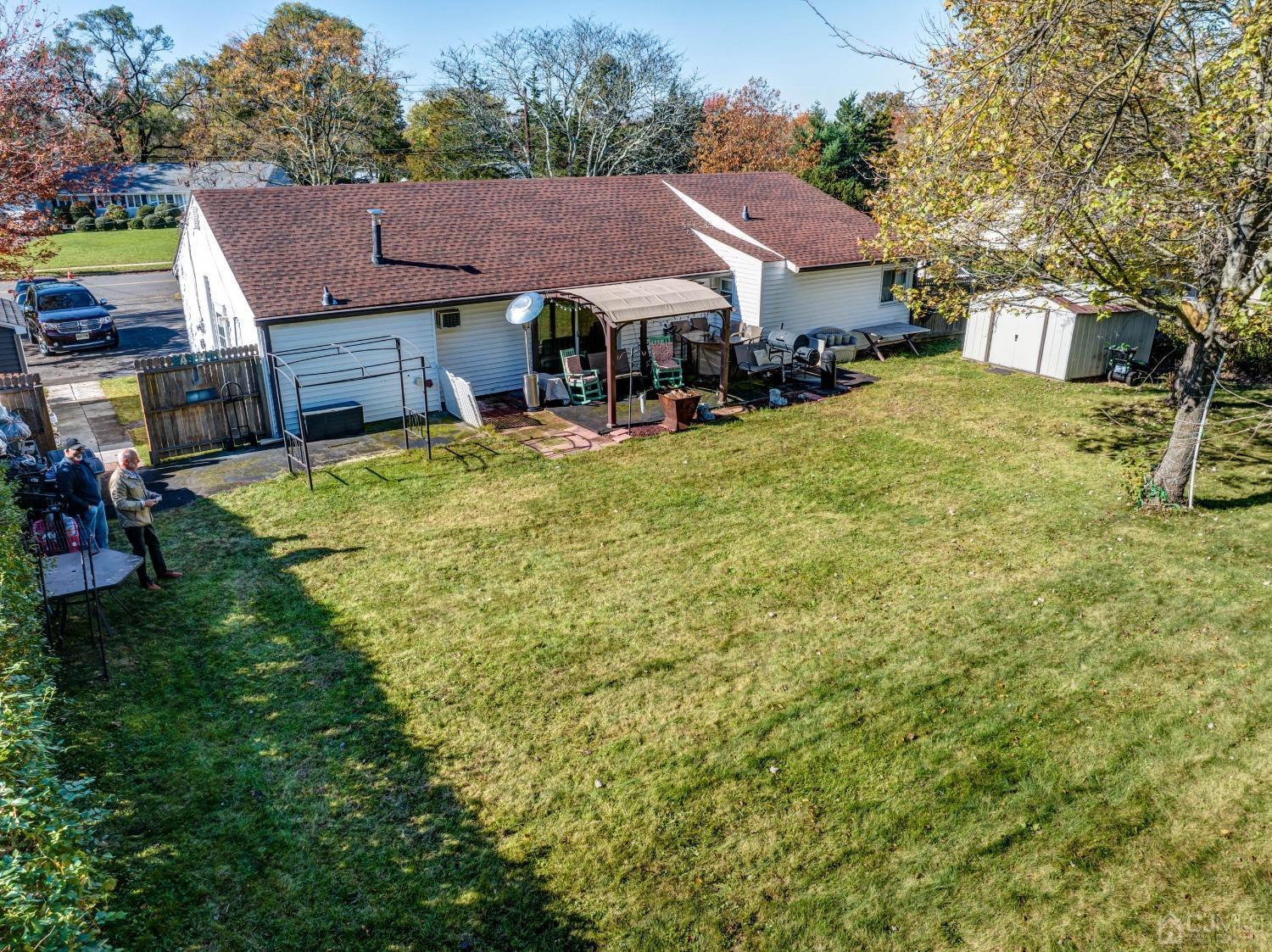 30 Cambridge Road Kendall Park, NJ 08824 - Photo 40 of 43 a view of house with yard and car parked