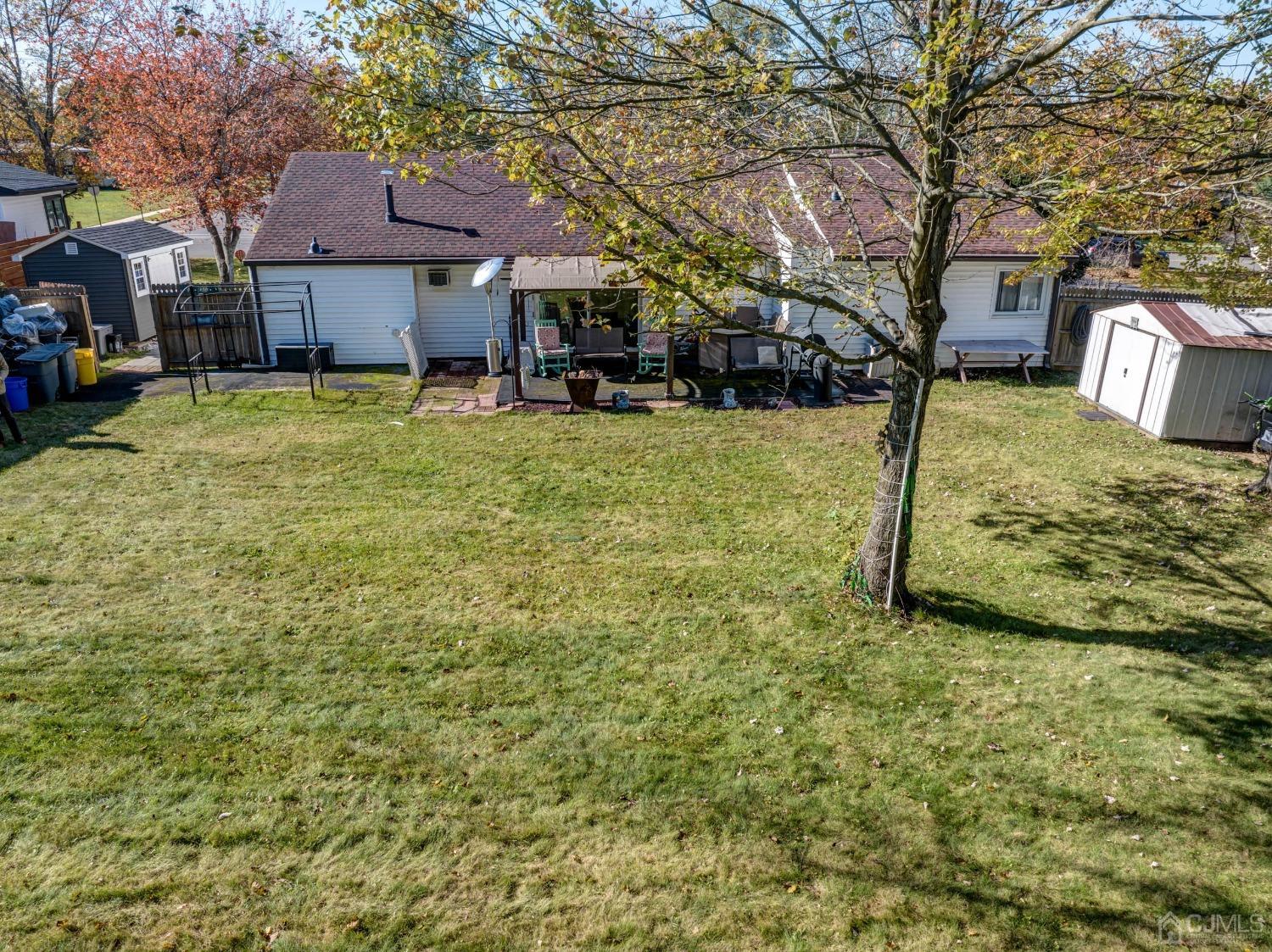 30 Cambridge Road Kendall Park, NJ 08824 - Photo 41 of 43 a view of a yard with brick house and a large tree