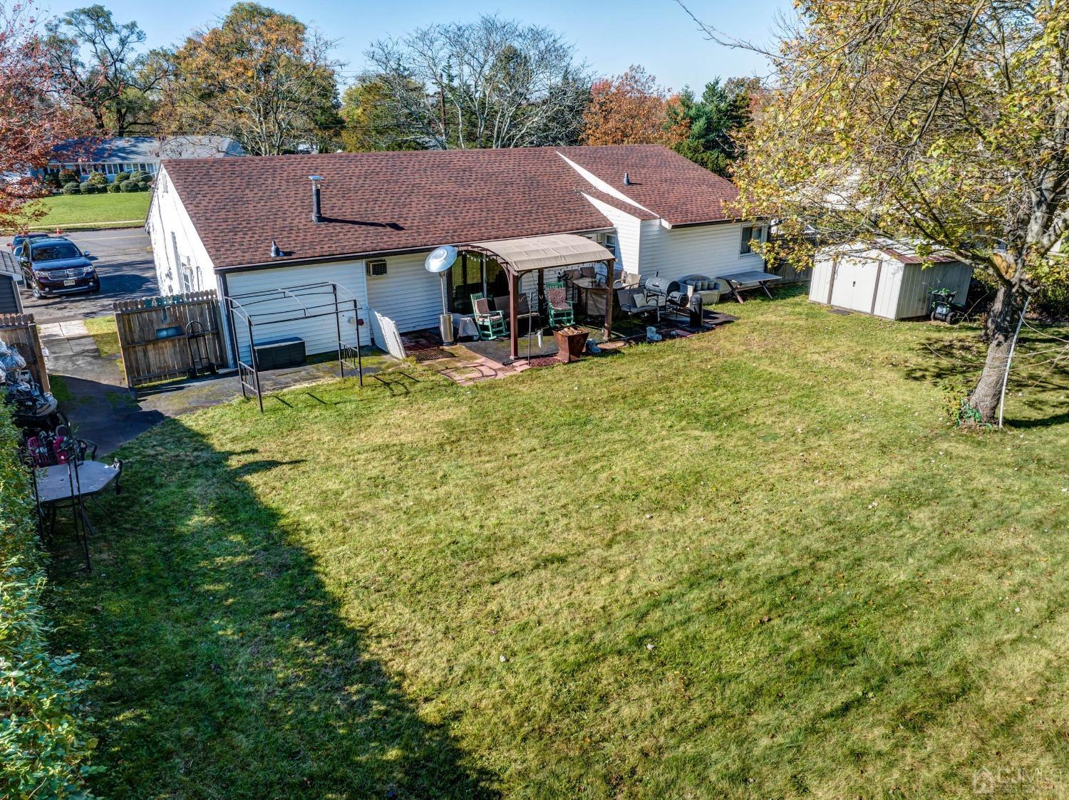 30 Cambridge Road Kendall Park, NJ 08824 - Photo 42 of 43 a view of house with yard and car parked