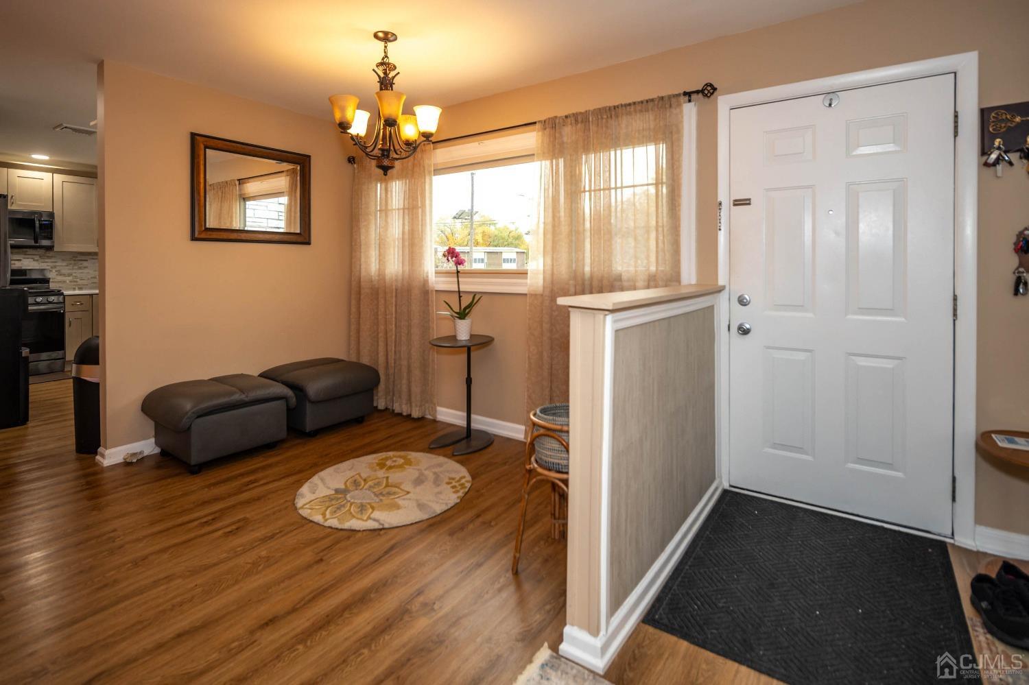 30 Cambridge Road Kendall Park, NJ 08824 - Photo 5 of 43 a living room with furniture and a chandelier