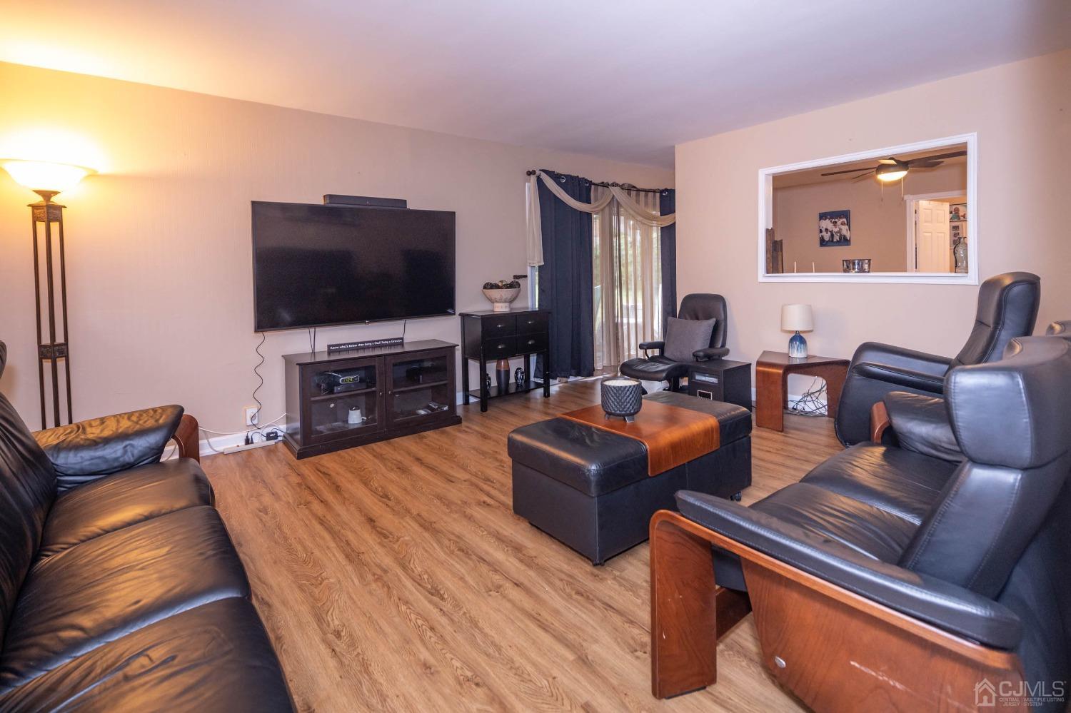 30 Cambridge Road Kendall Park, NJ 08824 - Photo 7 of 43 a living room with furniture and a flat screen tv