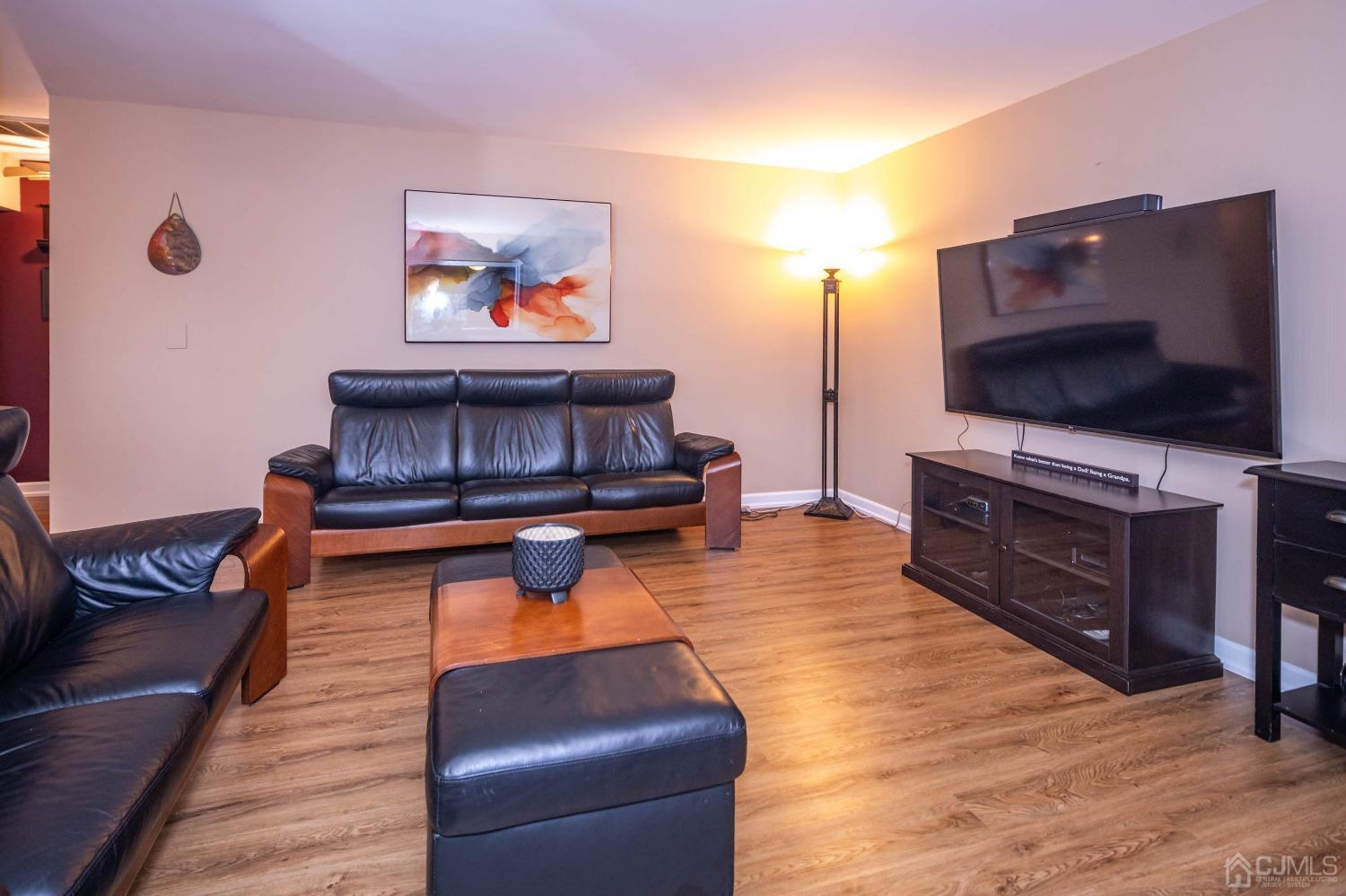 30 Cambridge Road Kendall Park, NJ 08824 - Photo 8 of 43 a living room with furniture and a flat screen tv