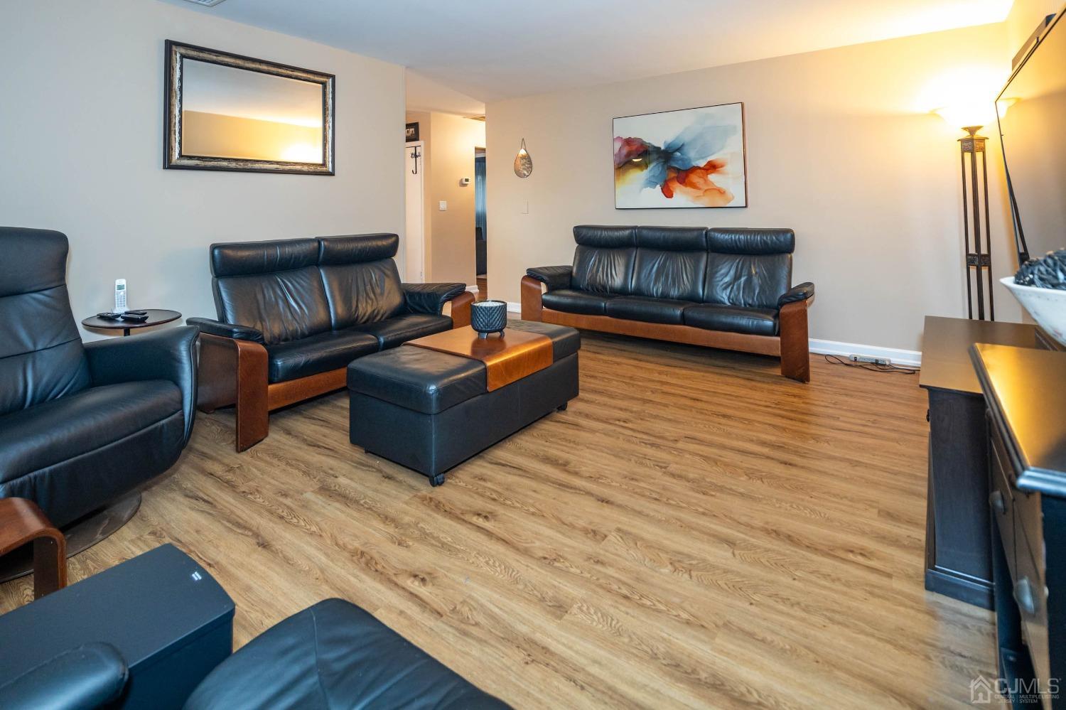30 Cambridge Road Kendall Park, NJ 08824 - Photo 9 of 43 a living room with furniture and a wooden floor