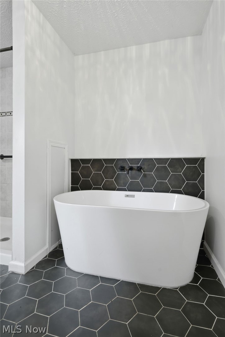 8160 Joyce Road Broadview Heights, OH 44147 - Photo 23 of 45 Freestanding soaking tub with dark hexagonal tile surround