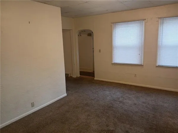 an empty room that has a mirror