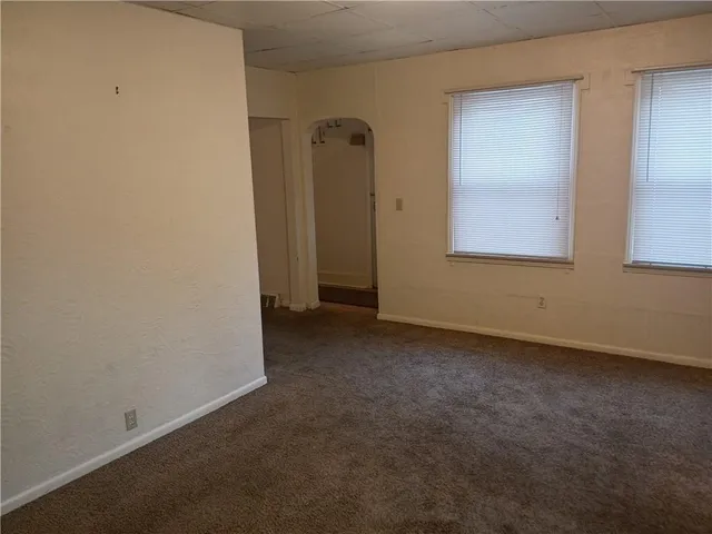 an empty room that has a mirror