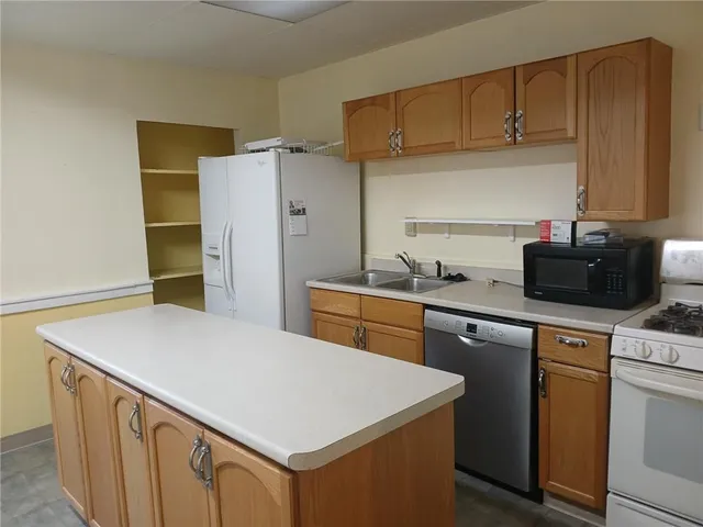 a view of backyard with wooden fence