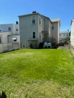 a view of a house with a backyard