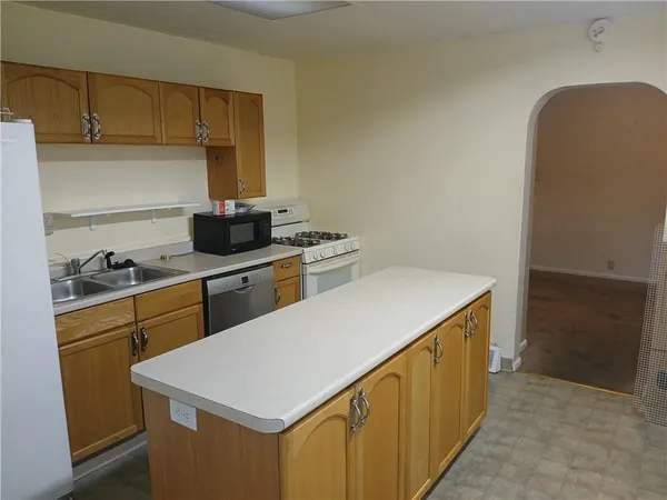 a kitchen with a sink a stove and a refrigerator