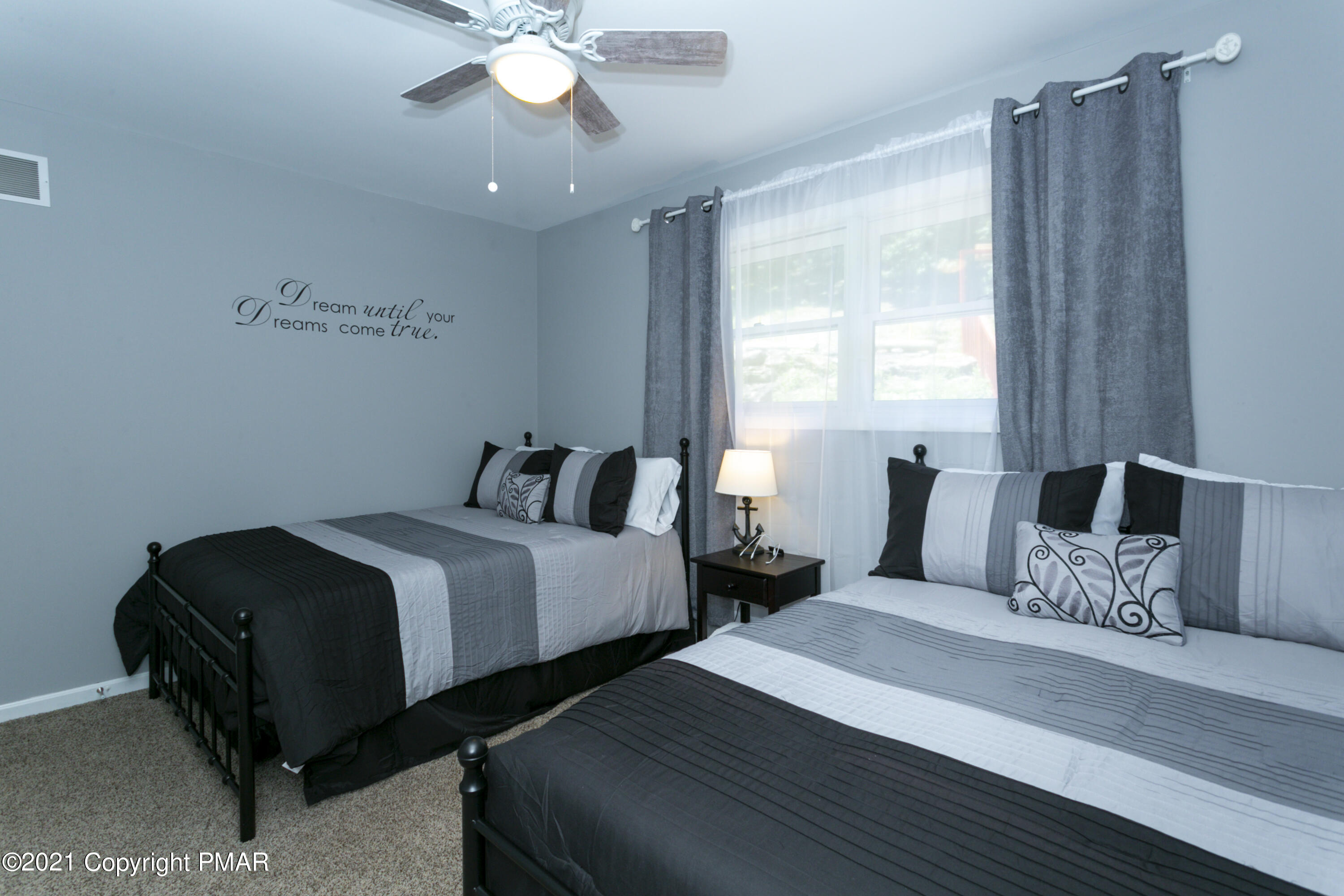 2155 Lancaster Drive Bushkill, PA 18324 - Photo 24 of 57 a bedroom with two beds and a chandelier