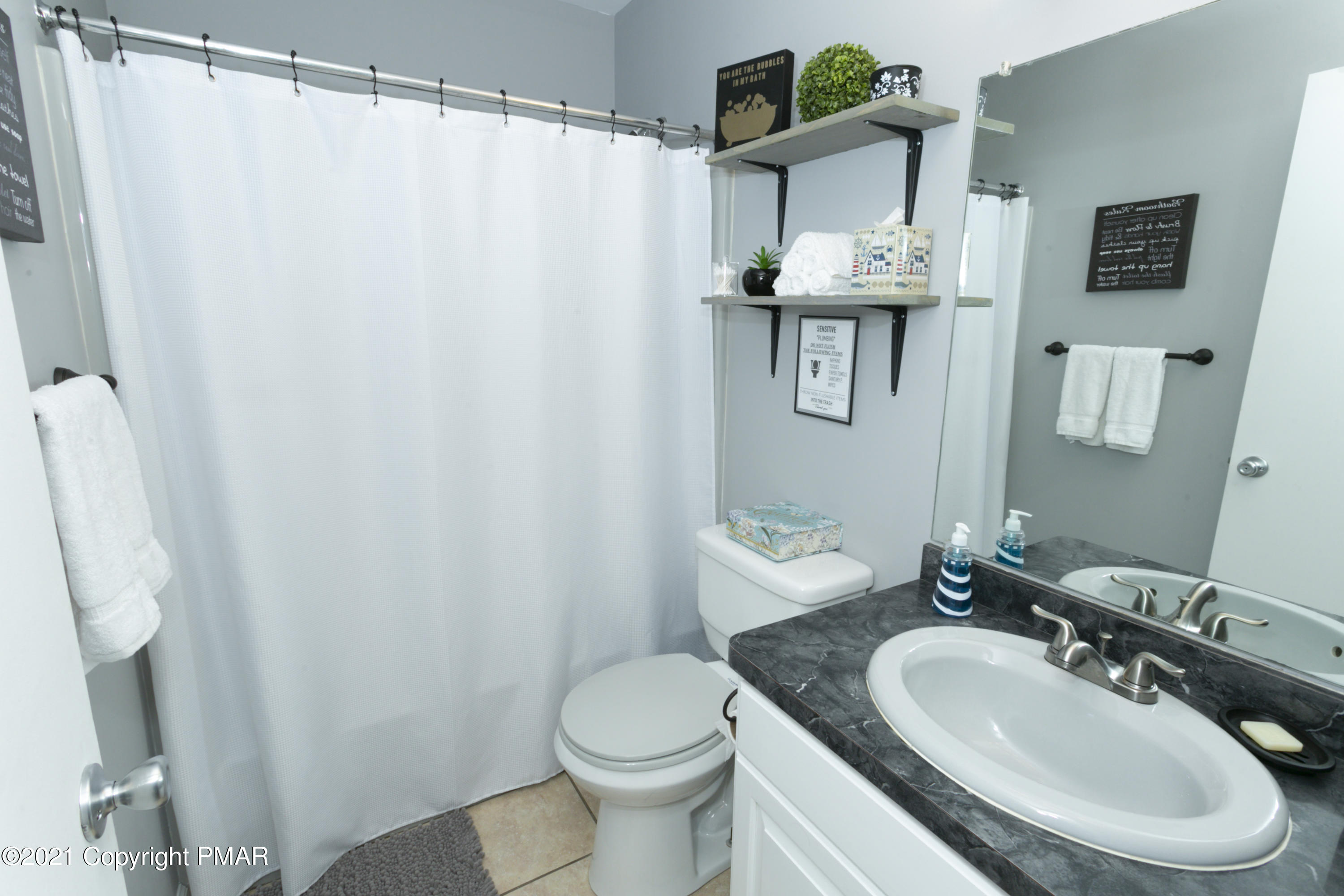 2155 Lancaster Drive Bushkill, PA 18324 - Photo 27 of 57 a bathroom with a sink toilet and mirror