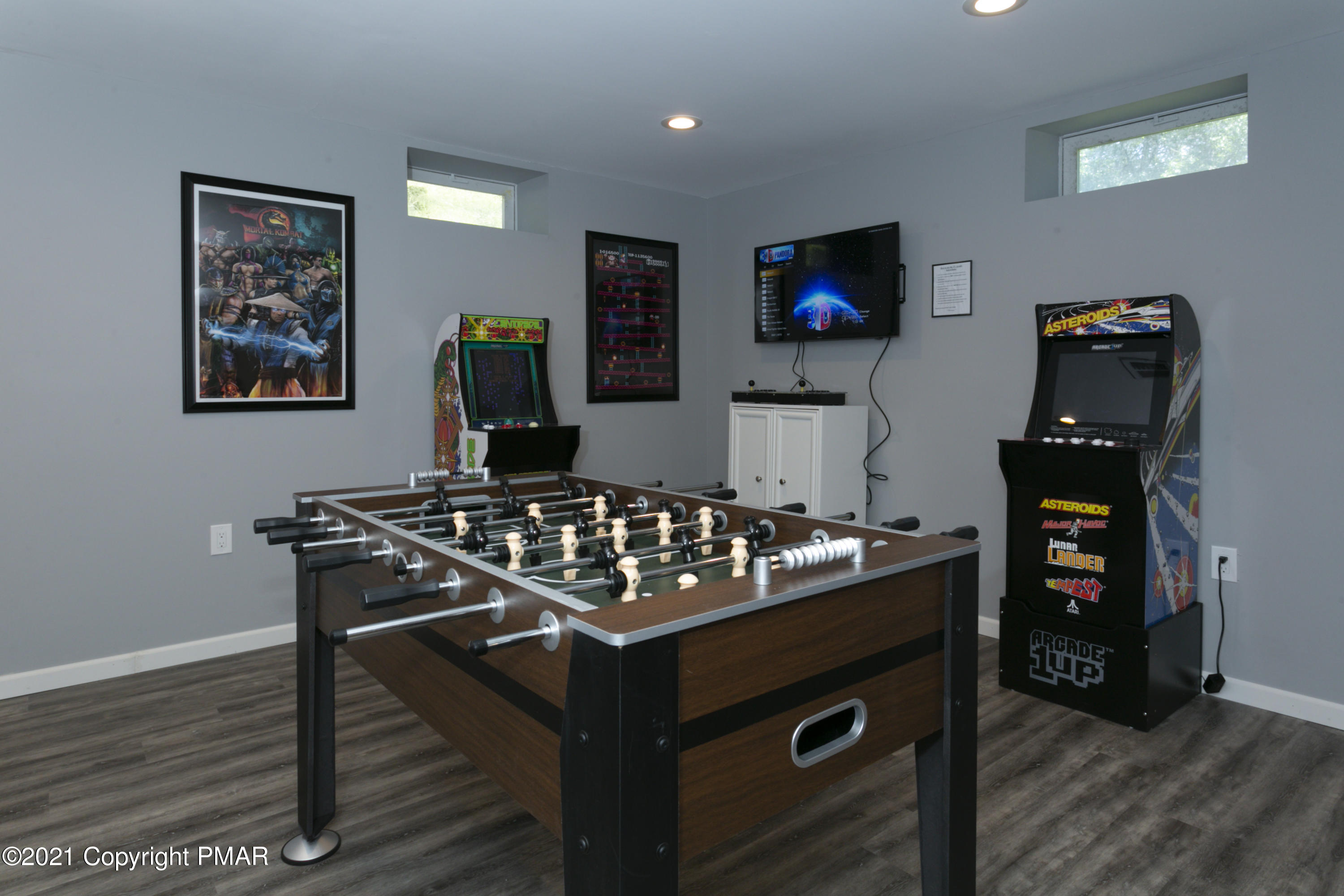 2155 Lancaster Drive Bushkill, PA 18324 - Photo 31 of 57 a living room with furniture a flat screen tv and a stove