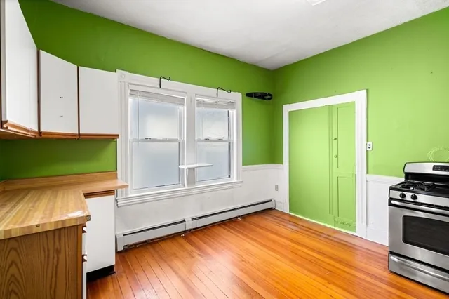 a view of a room with wooden floor and cabinet