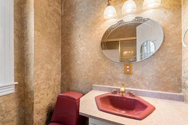 a bathroom with a sink and mirror