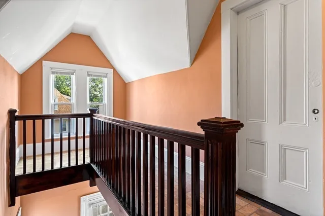 a view of a room with a window and wooden floor