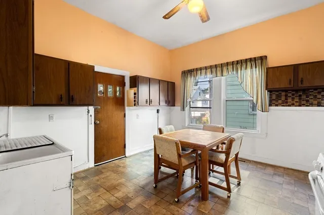 a dining room with furniture and window