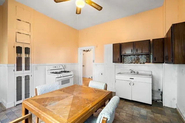 a kitchen with a stove a sink and a refrigerator