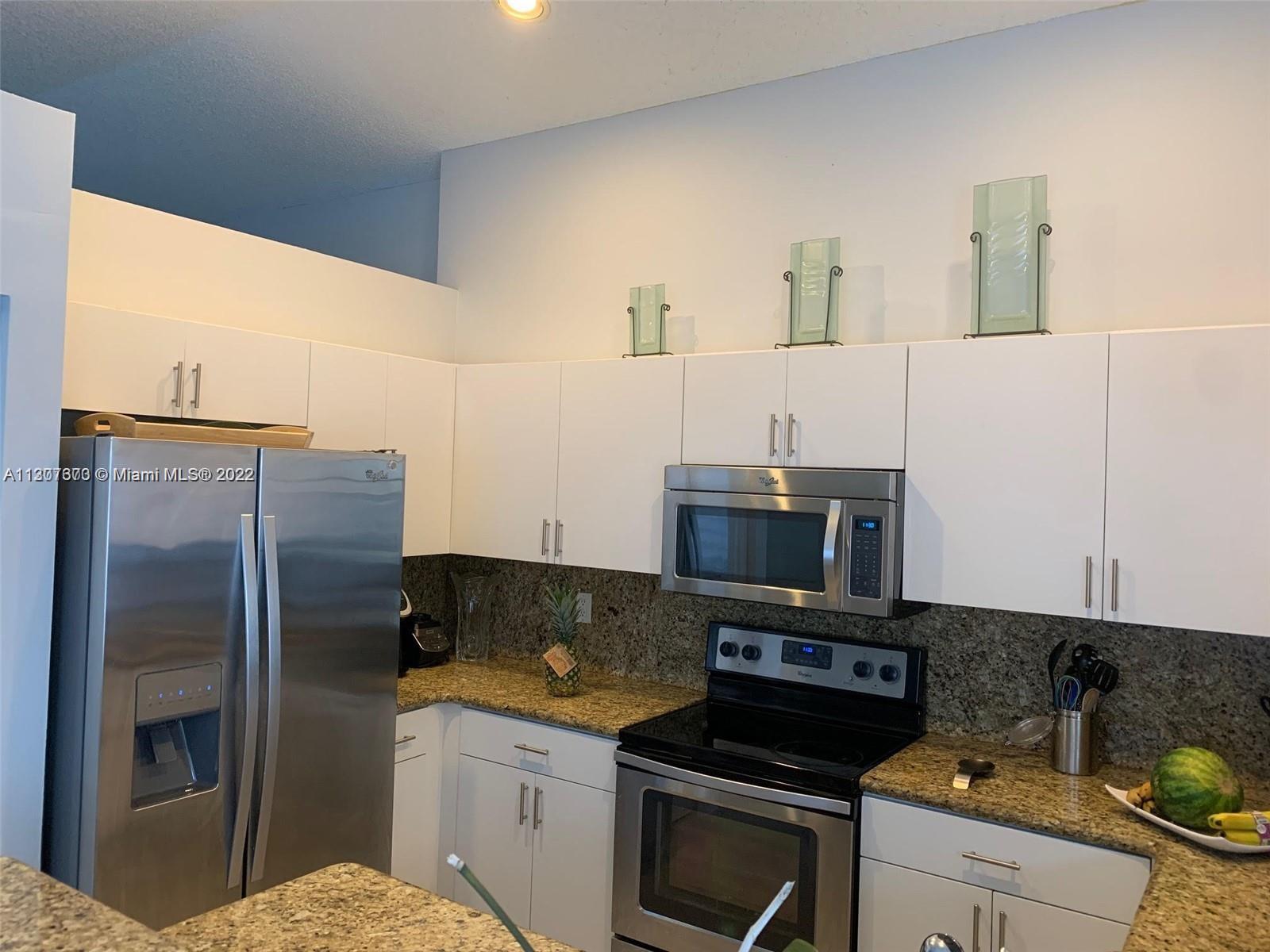 Savanna Weston, FL 33327 - Photo 11 of 24 a kitchen with stainless steel appliances granite countertop a refrigerator and a stove