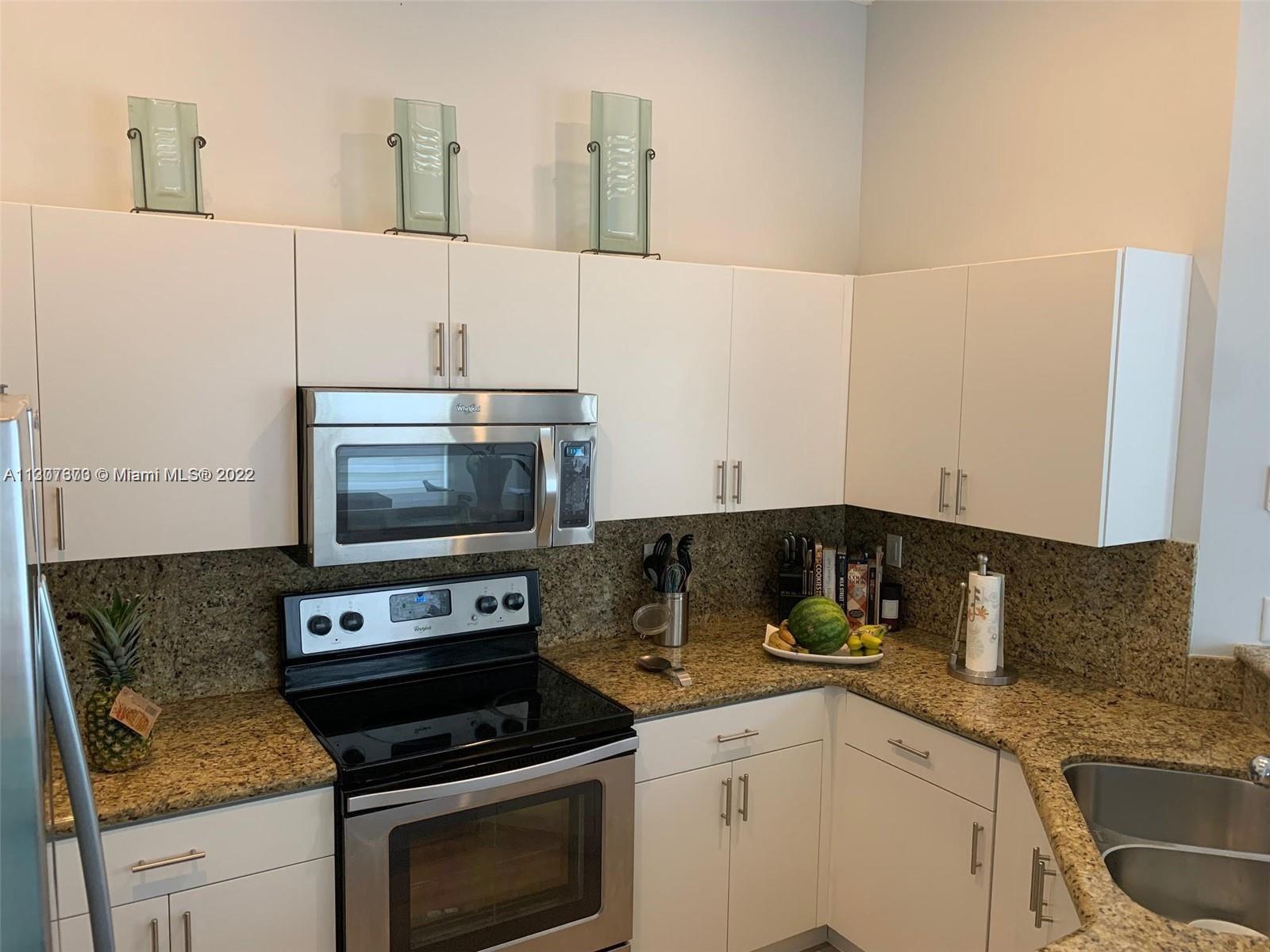 Savanna Weston, FL 33327 - Photo 13 of 24 a kitchen with granite countertop a stove and a sink