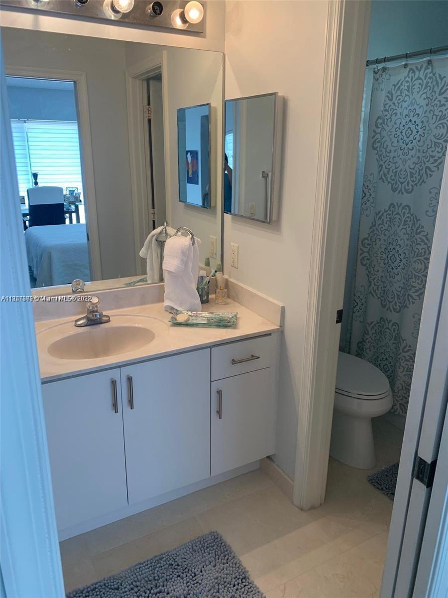 Savanna Weston, FL 33327 - Photo 19 of 24 a bathroom with a sink a toilet and mirror