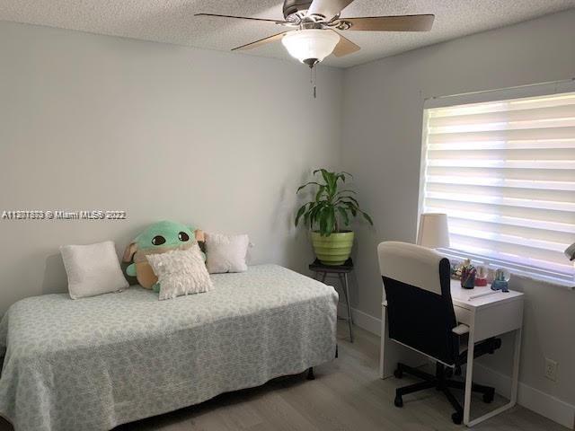 Savanna Weston, FL 33327 - Photo 20 of 24 a bedroom with a bed table chair and a window