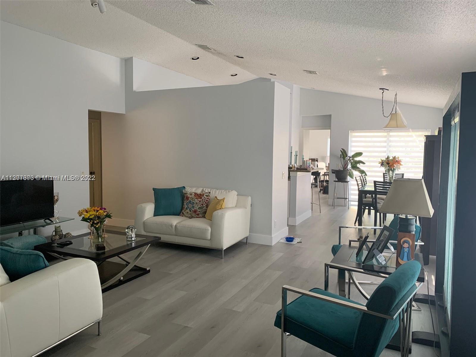 Savanna Weston, FL 33327 - Photo 2 of 24 a living room with furniture and a flat screen tv