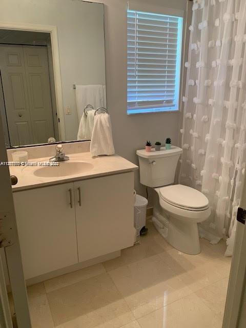 Savanna Weston, FL 33327 - Photo 21 of 24 a bathroom with a sink a toilet and a mirror