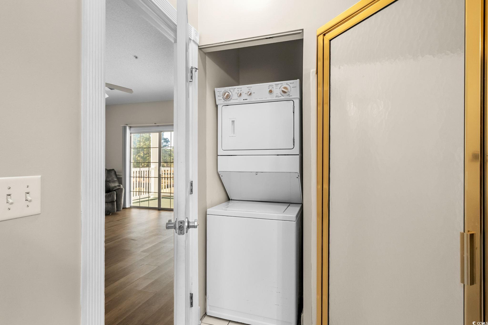 4815 Orchid Way, Unit 302 Myrtle Beach, SC 29577 - Photo 17 of 26 Laundry room featuring stacked washer / dryer and wood finished floors
