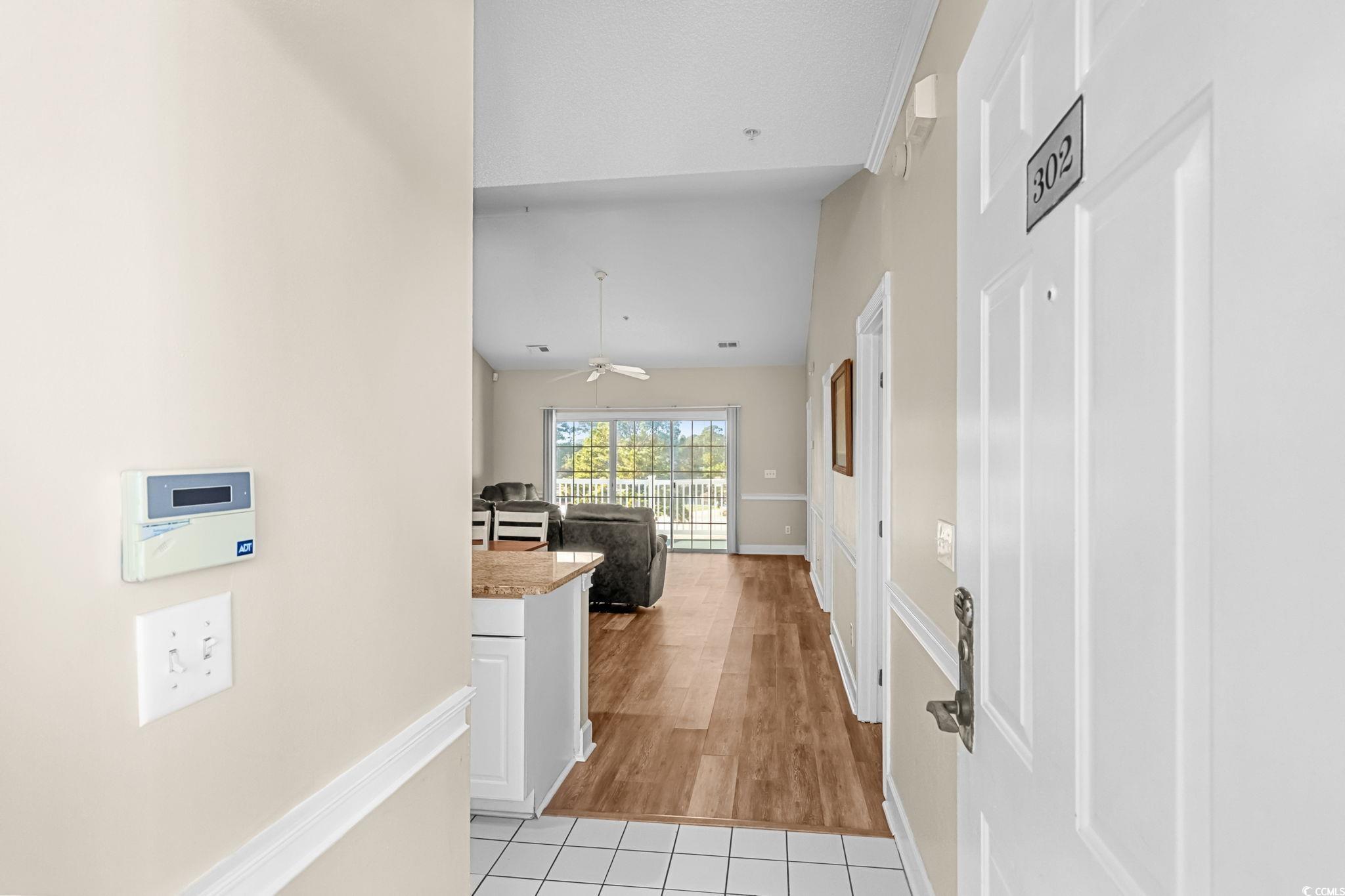 4815 Orchid Way, Unit 302 Myrtle Beach, SC 29577 - Photo 3 of 26 Corridor with light tile patterned floors and lofted ceiling